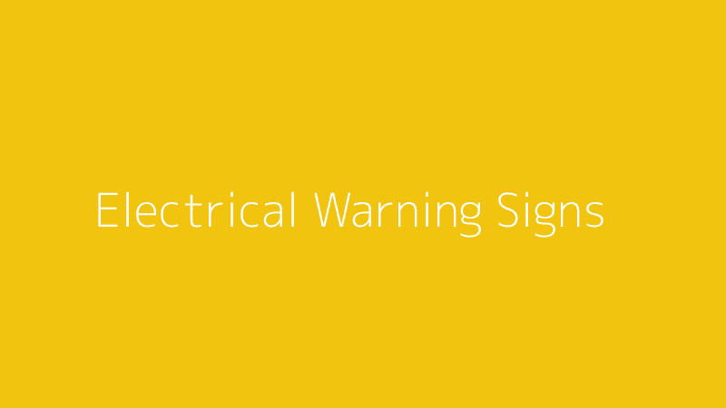 An electrical outlet with a warning sign superimposed, indicating potential danger.